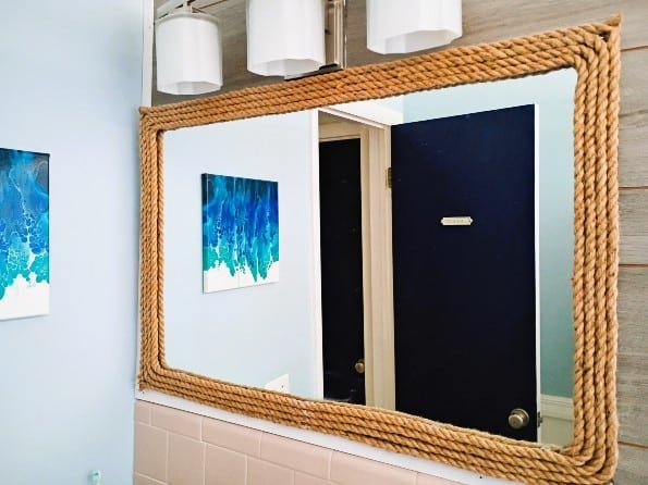 I spent under $35 to make this DIY nautical rope mirror decor for one of my bathrooms. And besides already having the mirror to do this - the project was super easy.  Finding the twine rope was difficult, mainly because I was picky - I wanted a thick, distressed and natural looking twine (not some poly-blend type rope, which is all I was finding).